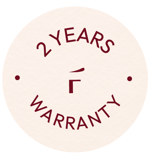 Circular badge with the text "2 YEARS WARRANTY" in dark red, surrounding a central symbol and two dots on either side.